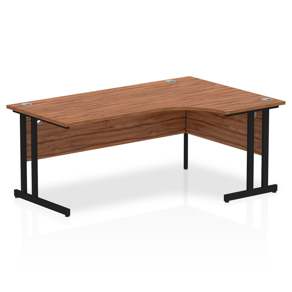 Walnut L-shaped desk with drawers on a white background