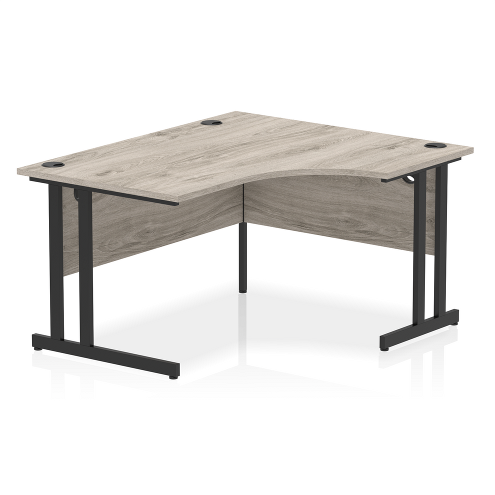 Grey oak L-shaped desk with drawers on a white background