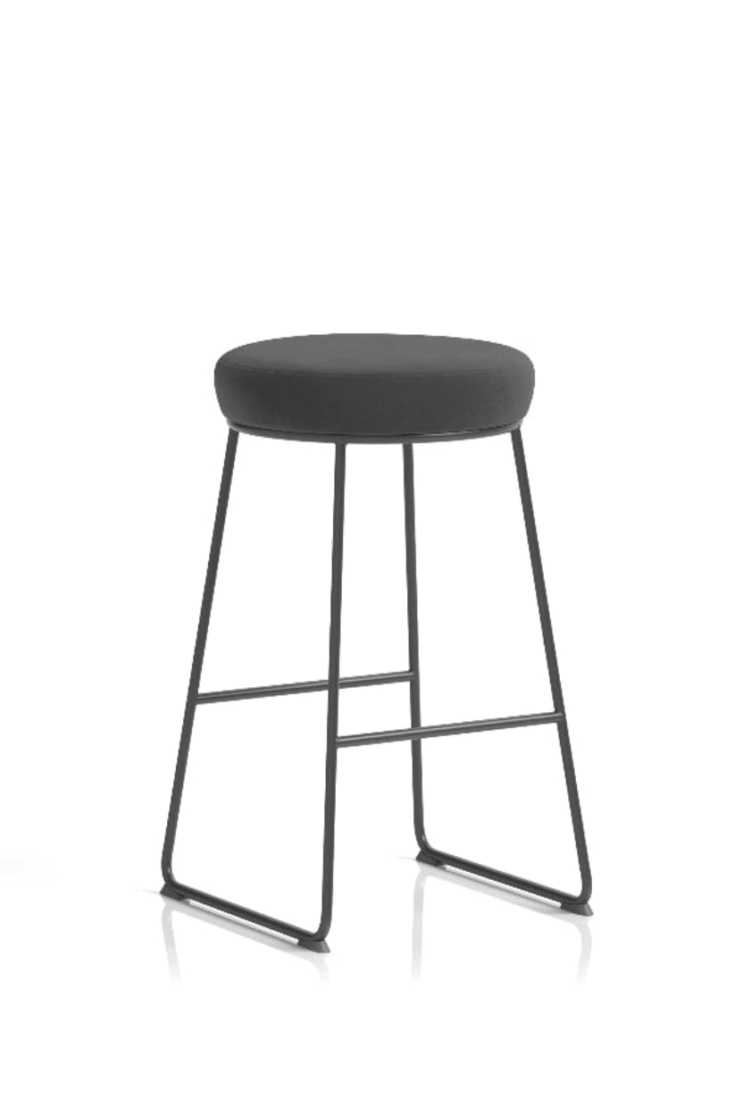 A modern style bar stool with a black fabric seat and a black metal frame, featuring dual footrests.