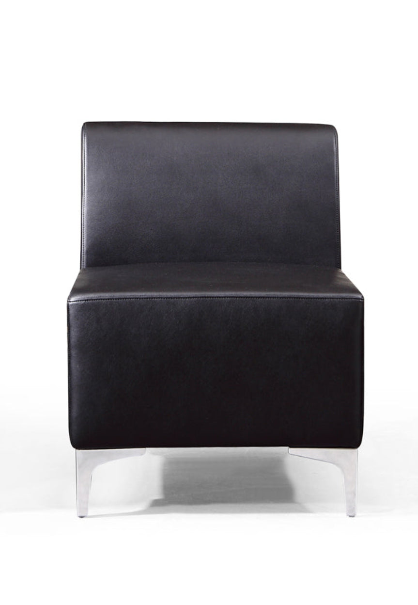 A black faux leather modular sofa section with chrome corner feet and no visible legs.