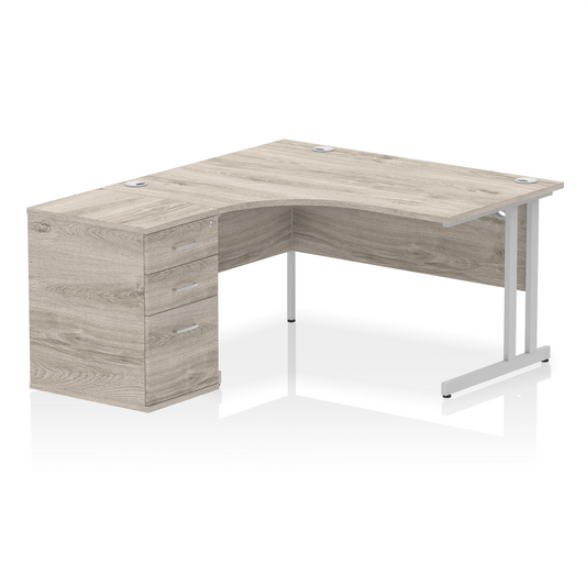 Impulse 1400mm Left Hand Curved Desk, Grey Oak Top with Silver Cantilver Legs inc 3 Drawer Desk High Pedestal