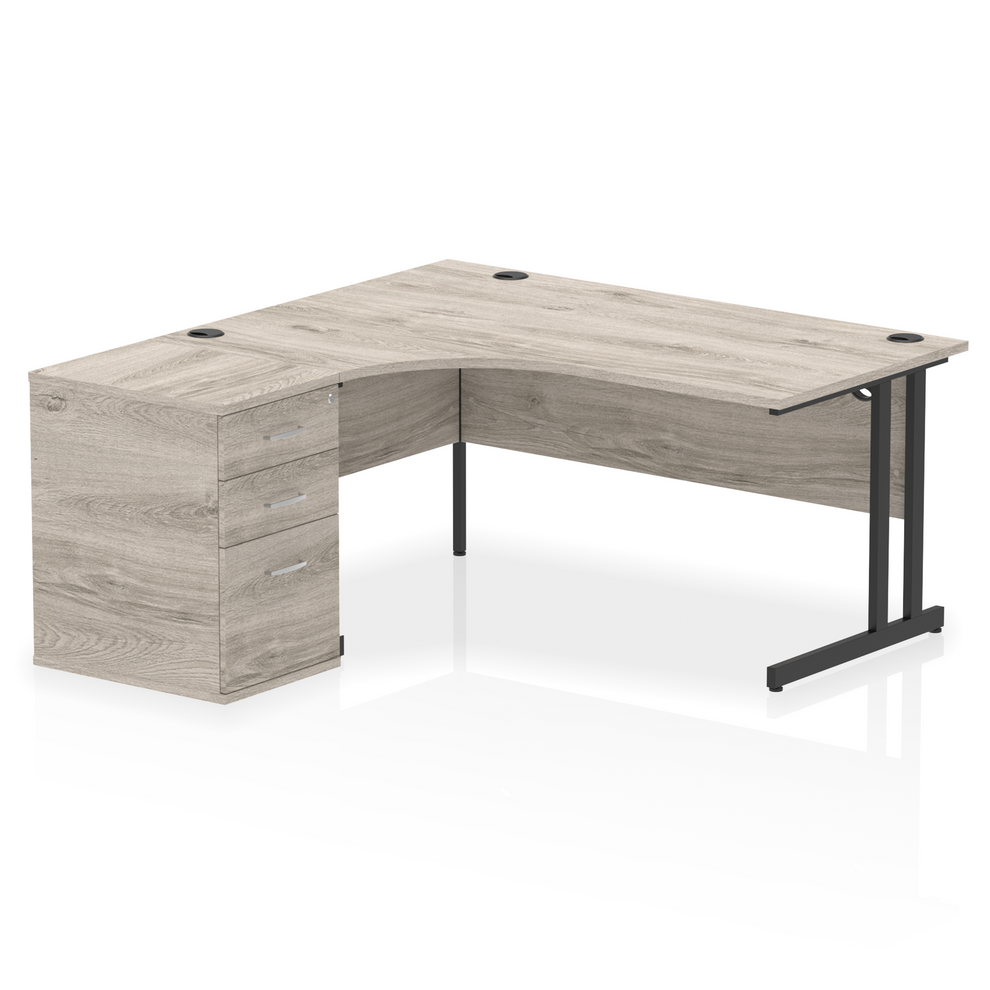 Grey oak L-shaped desk with drawers on a white background