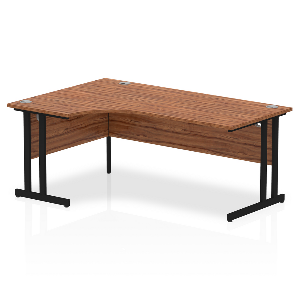 Walnut L-shaped desk with drawers on a white background