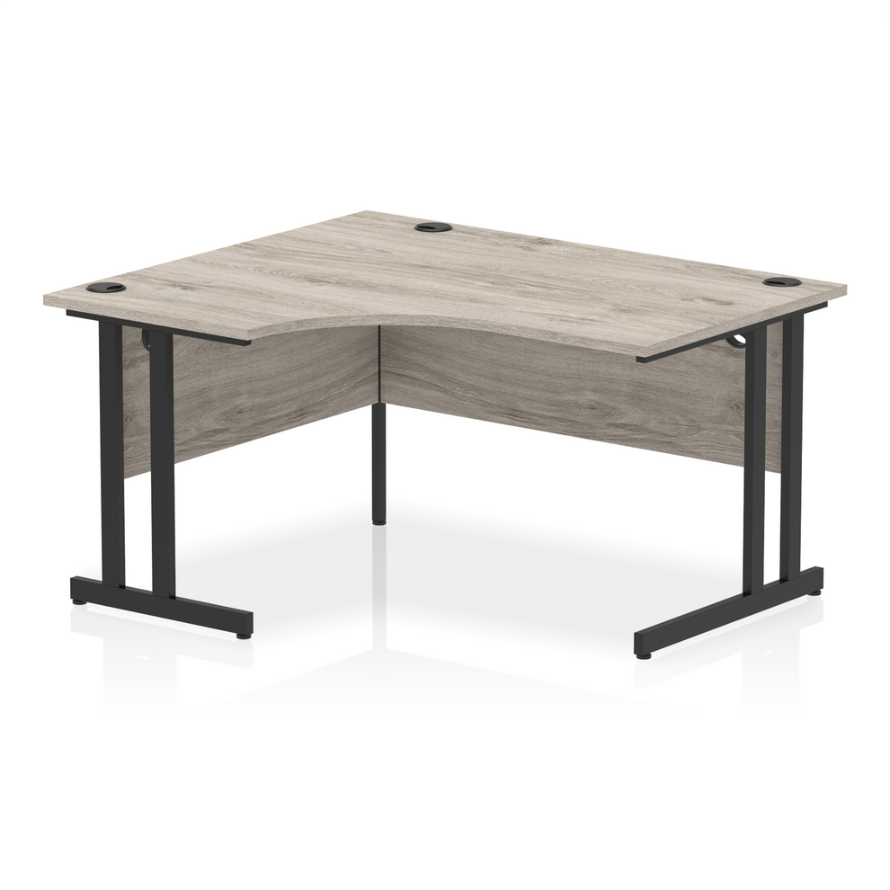 Grey oak L-shaped desk with drawers on a white background