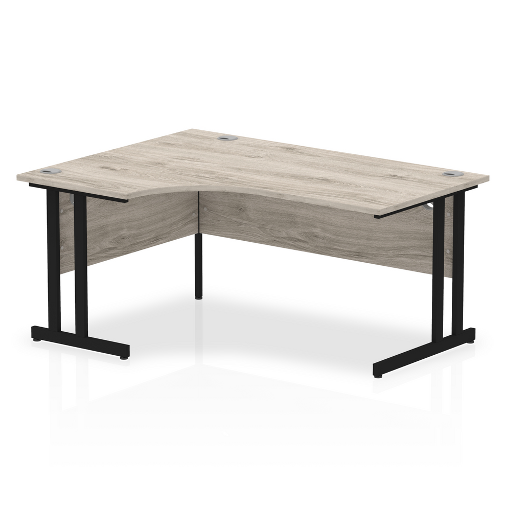 Grey oak L-shaped desk with drawers on a white background