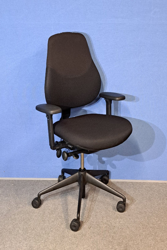 Black office chair against a blue wall
