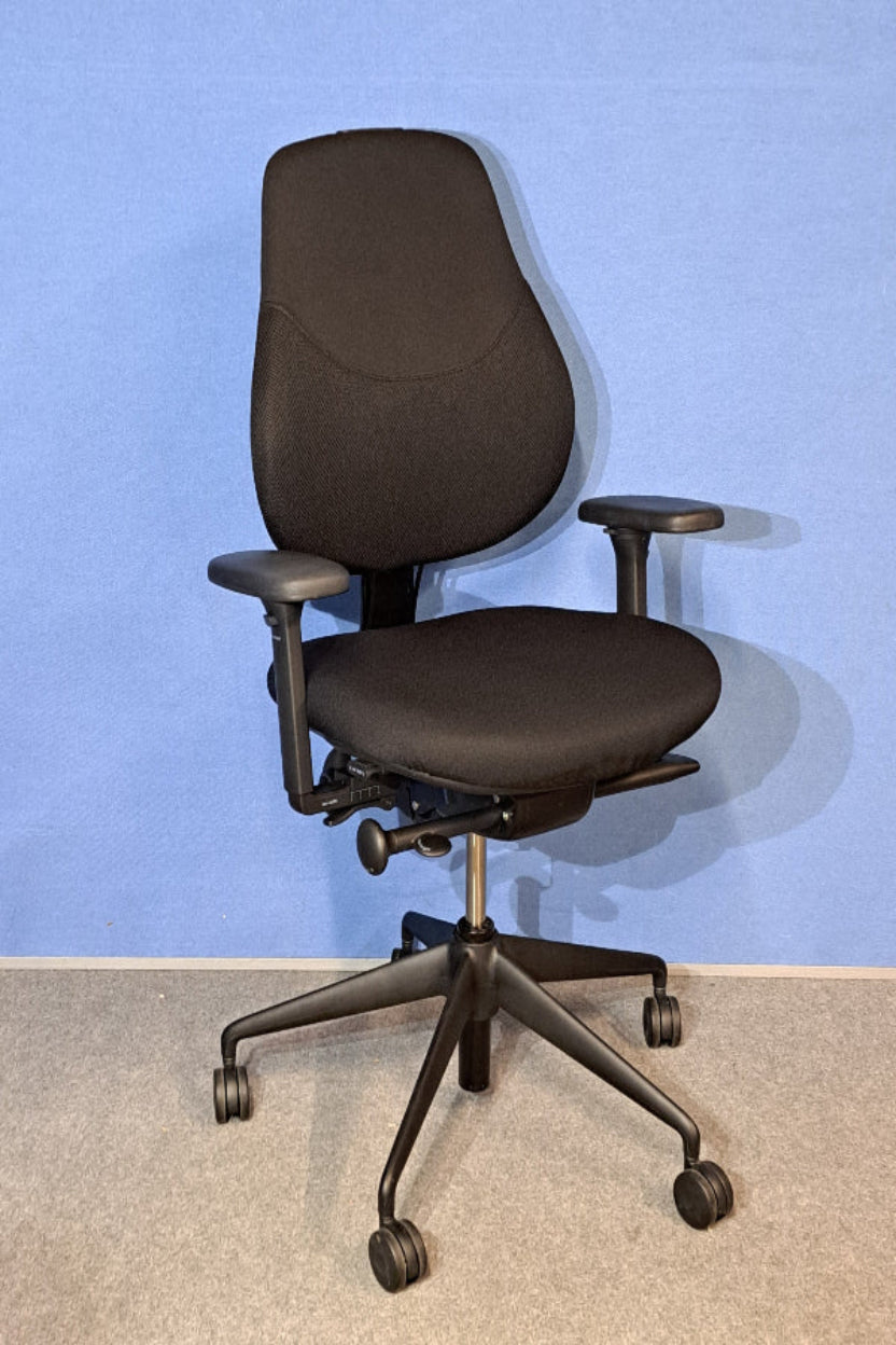 Black office chair against a blue wall