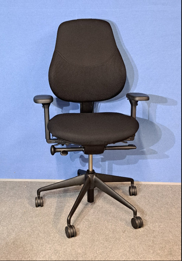 Black office chair against a blue wall
