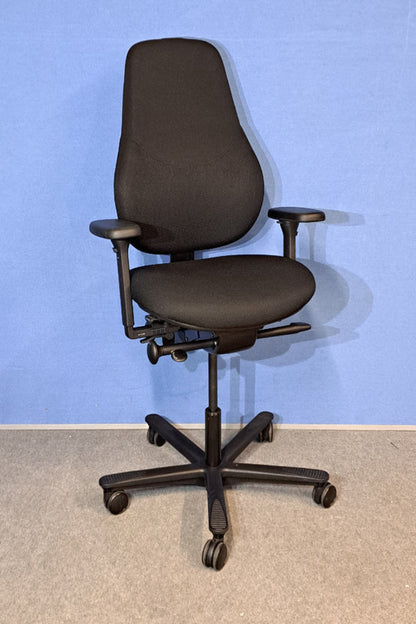Black office chair against a blue wall