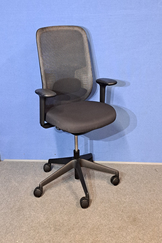 Office chair with mesh backrest on a blue and grey floor.
