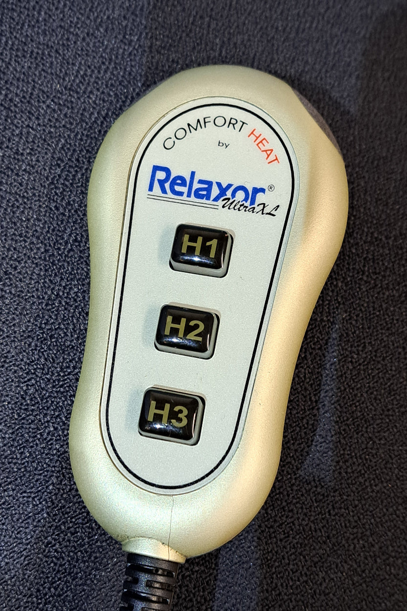 Relaxor Comfort Heat device with three settings on a dark textured surface