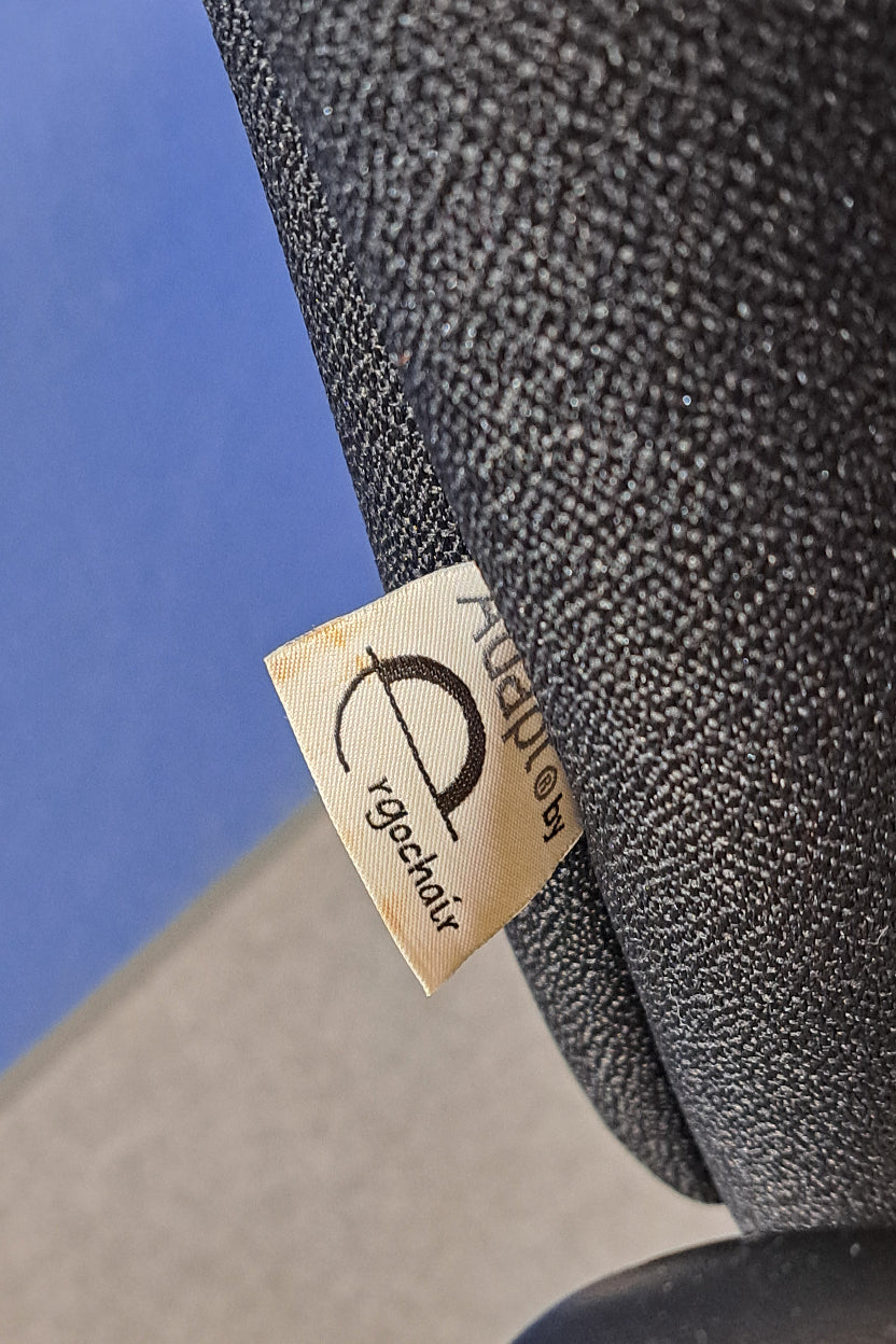 Close-up of a textured black surface with an 'ErgoChair' label.