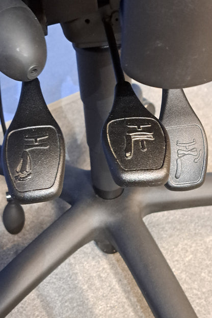Close-up of levers on a chair with a grey and blue background