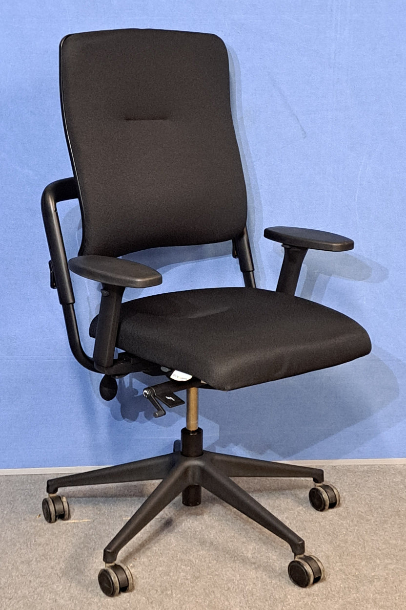 Black office chair against a blue wall