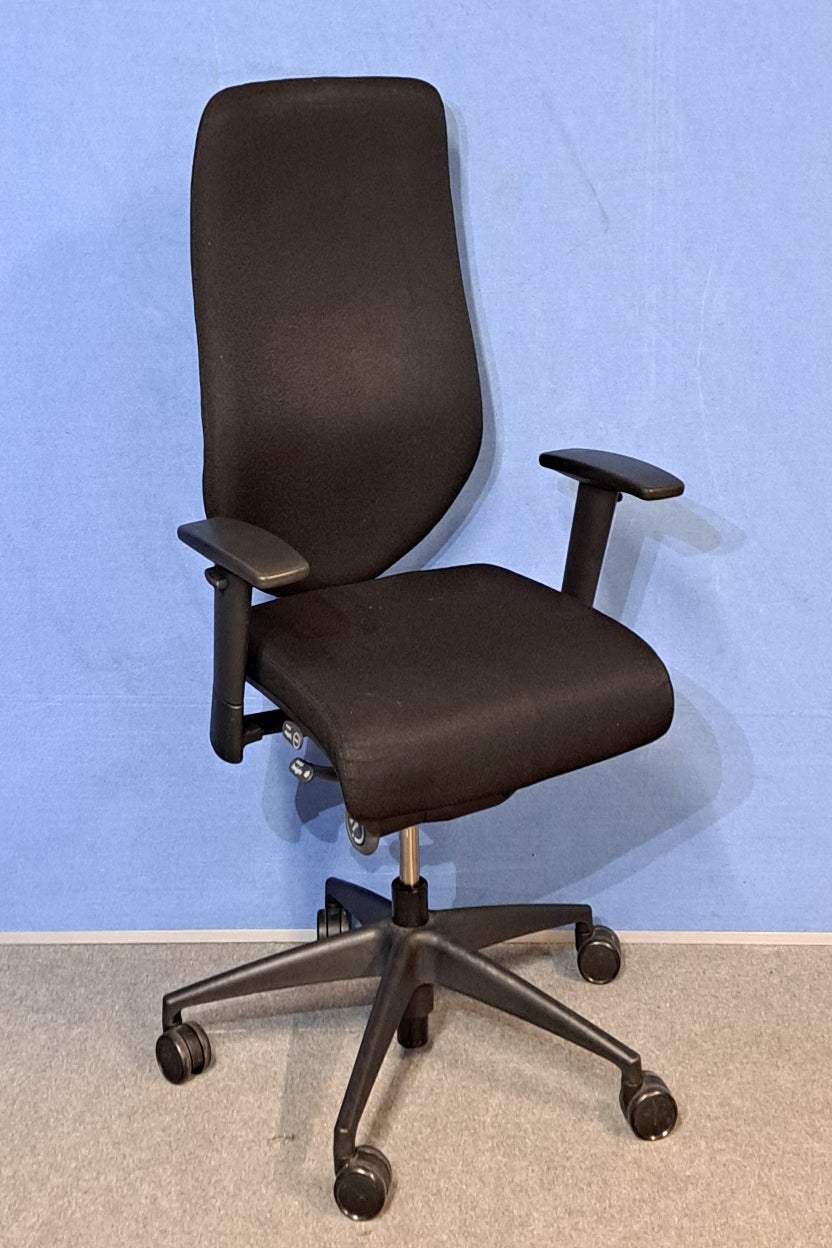 Black office chair on a blue background and grey floor