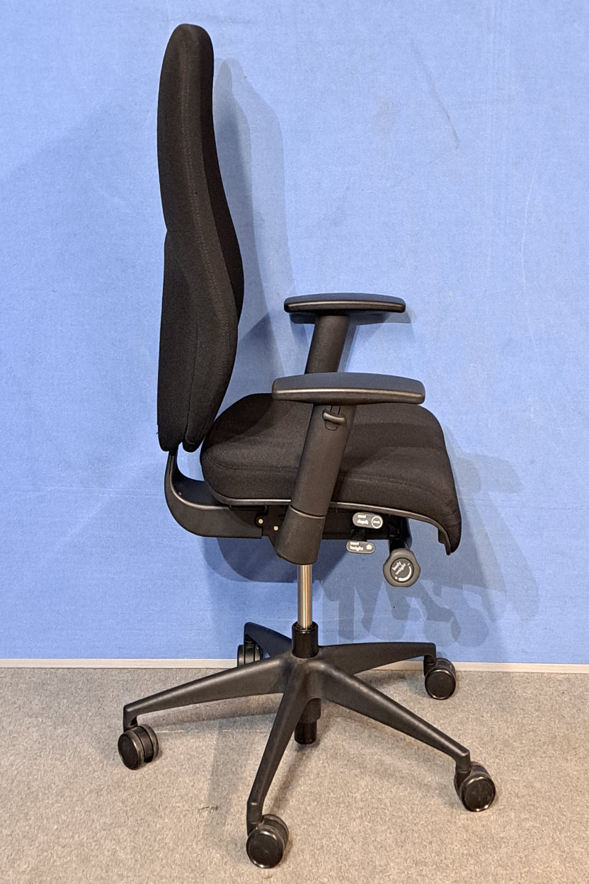 Black office chair on a blue background and grey floor