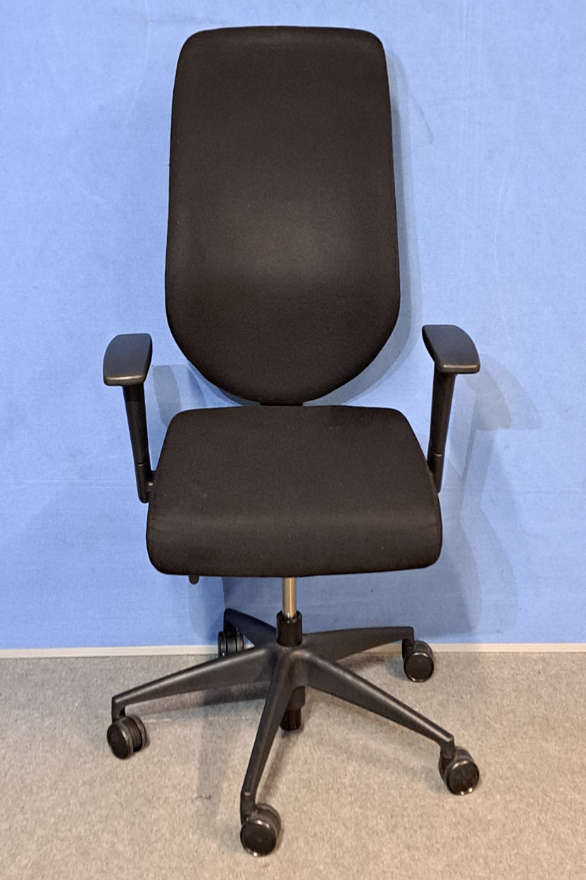 Black office chair on a blue background and grey floor