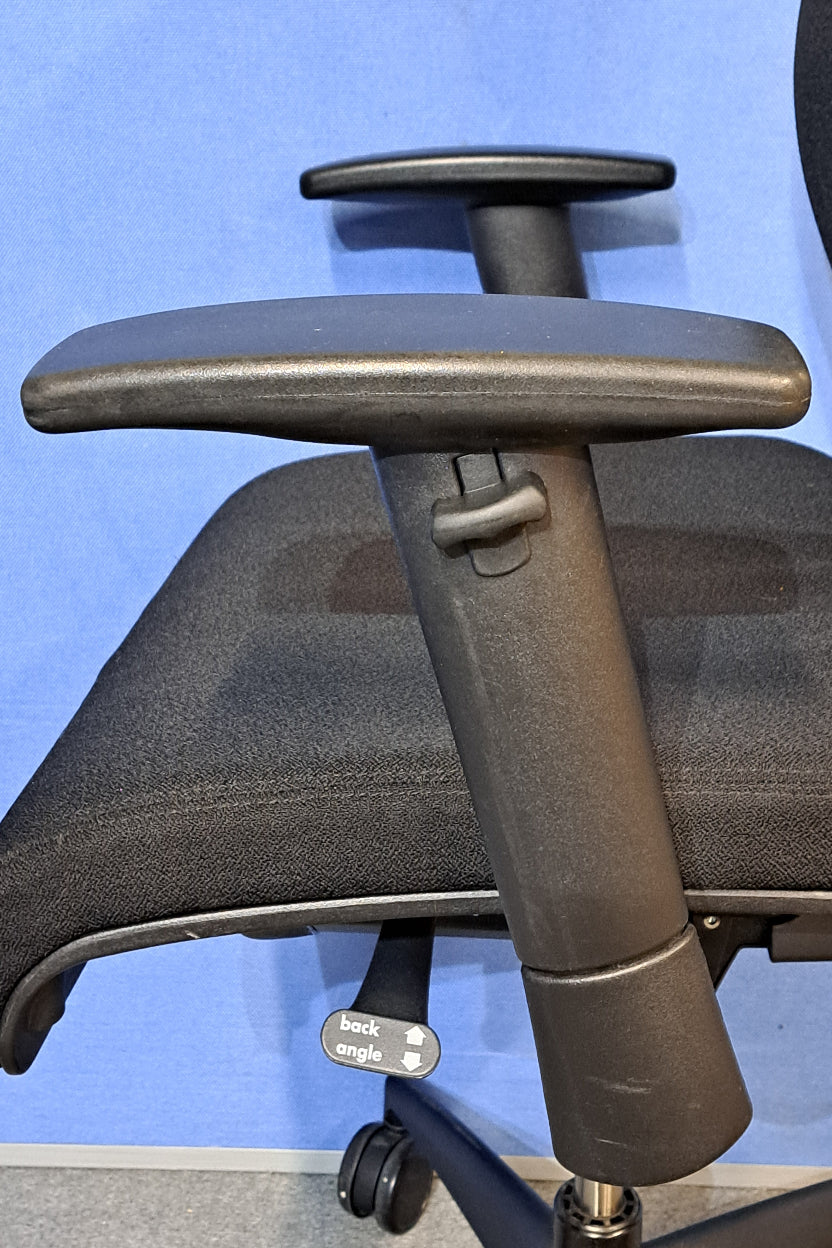 Black office chair on a blue background and grey floor