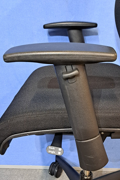 Black office chair on a blue background and grey floor