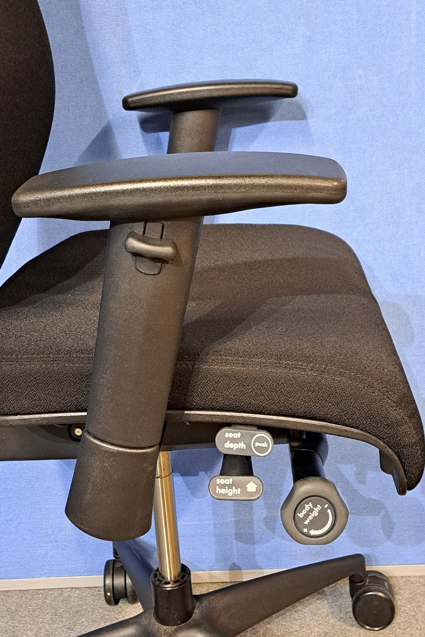 Black office chair on a blue background and grey floor