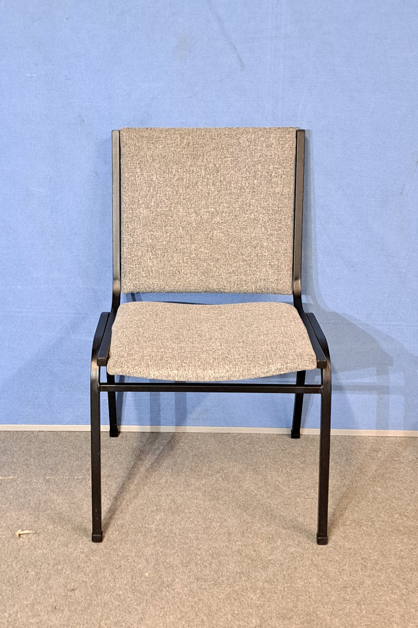 Grey meeting chair on a blue background and grey floor