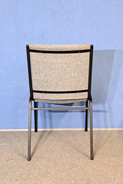 Grey meeting chair on a blue background and grey floor