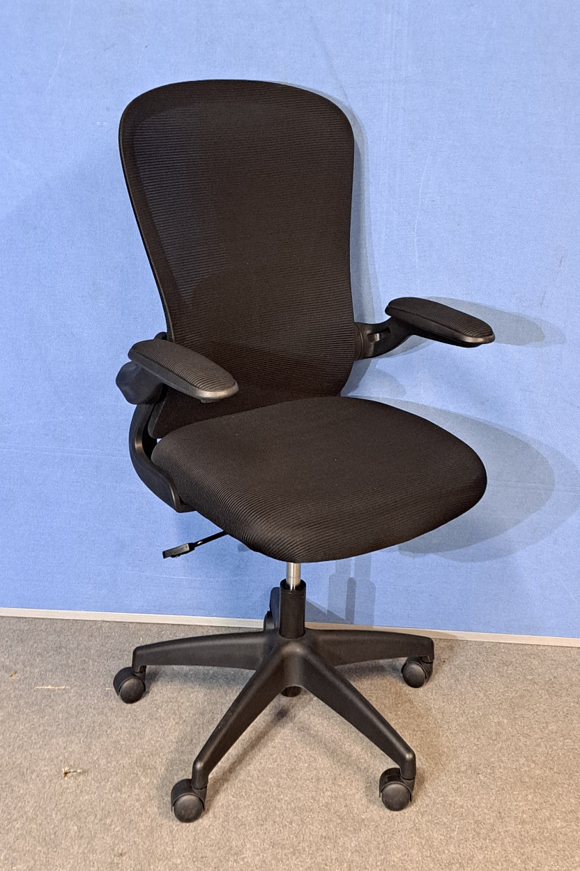 Black office chair on a blue background and grey floor