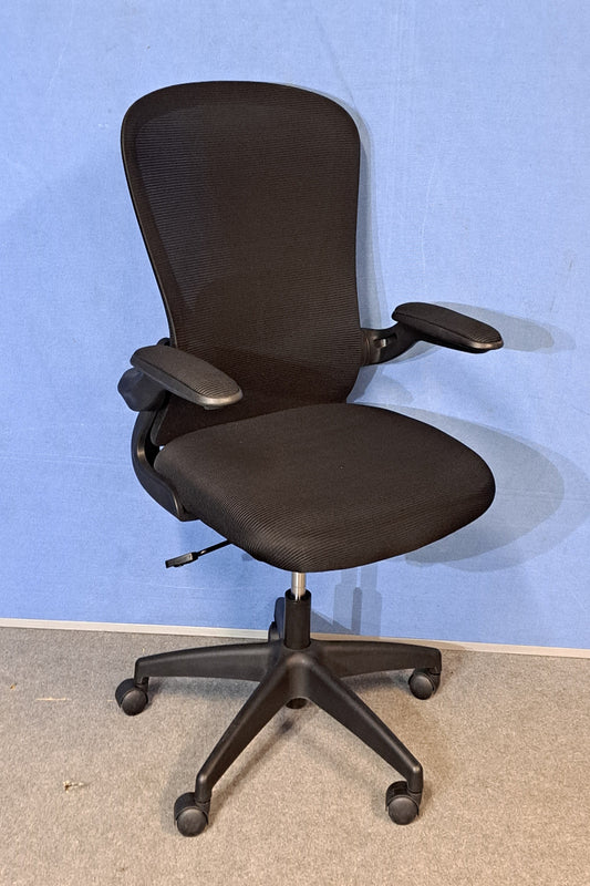 Black office chair on a blue background and grey floor