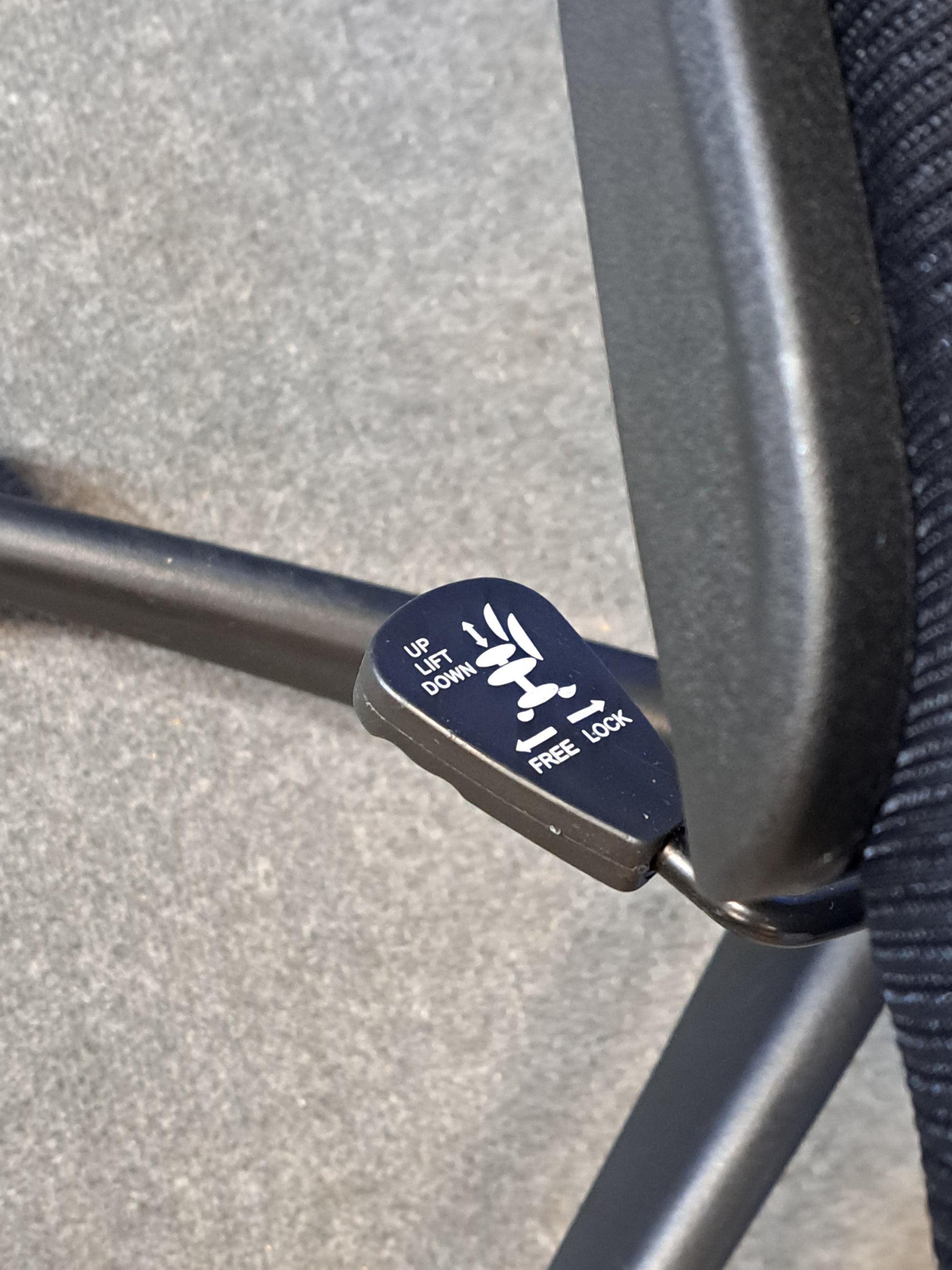 Black office chair on a blue background and grey floor