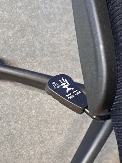Black office chair on a blue background and grey floor