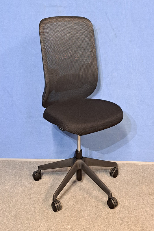 Black office chair on a blue wall and grey carpet