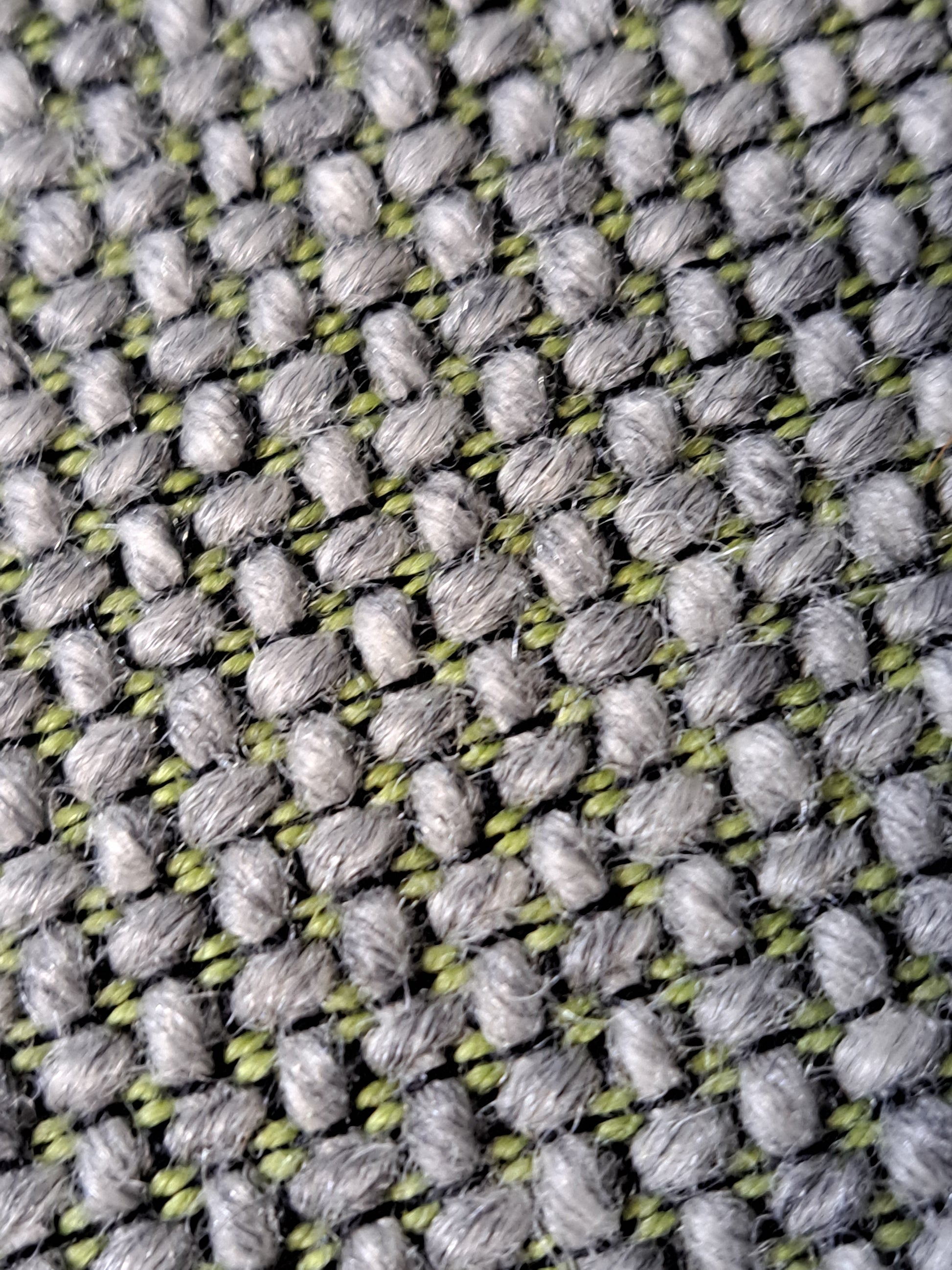Grey office chair on a blue wall and grey carpet