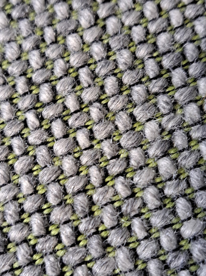 Grey office chair on a blue wall and grey carpet