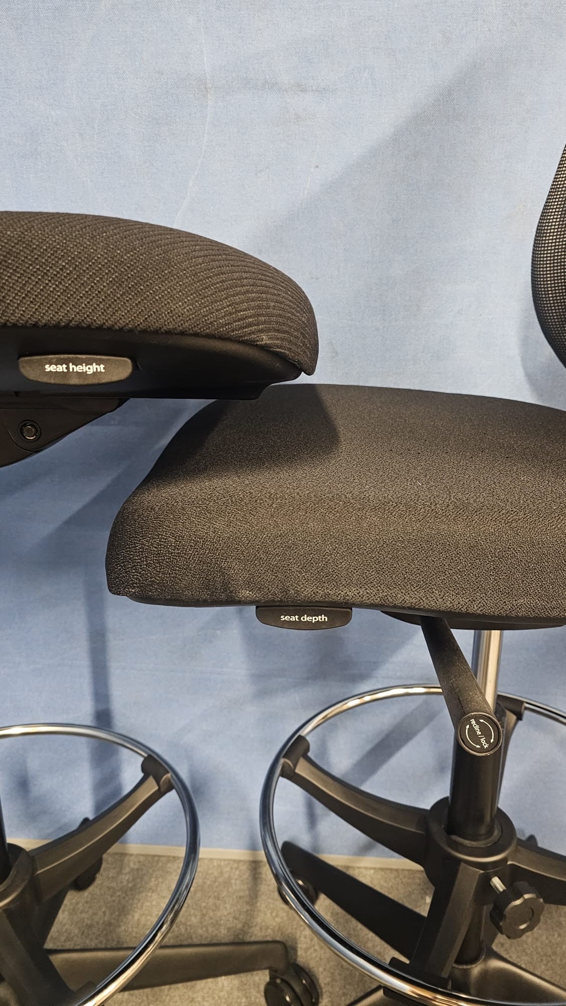Draughtsman chair on blue wall and grey carpet
