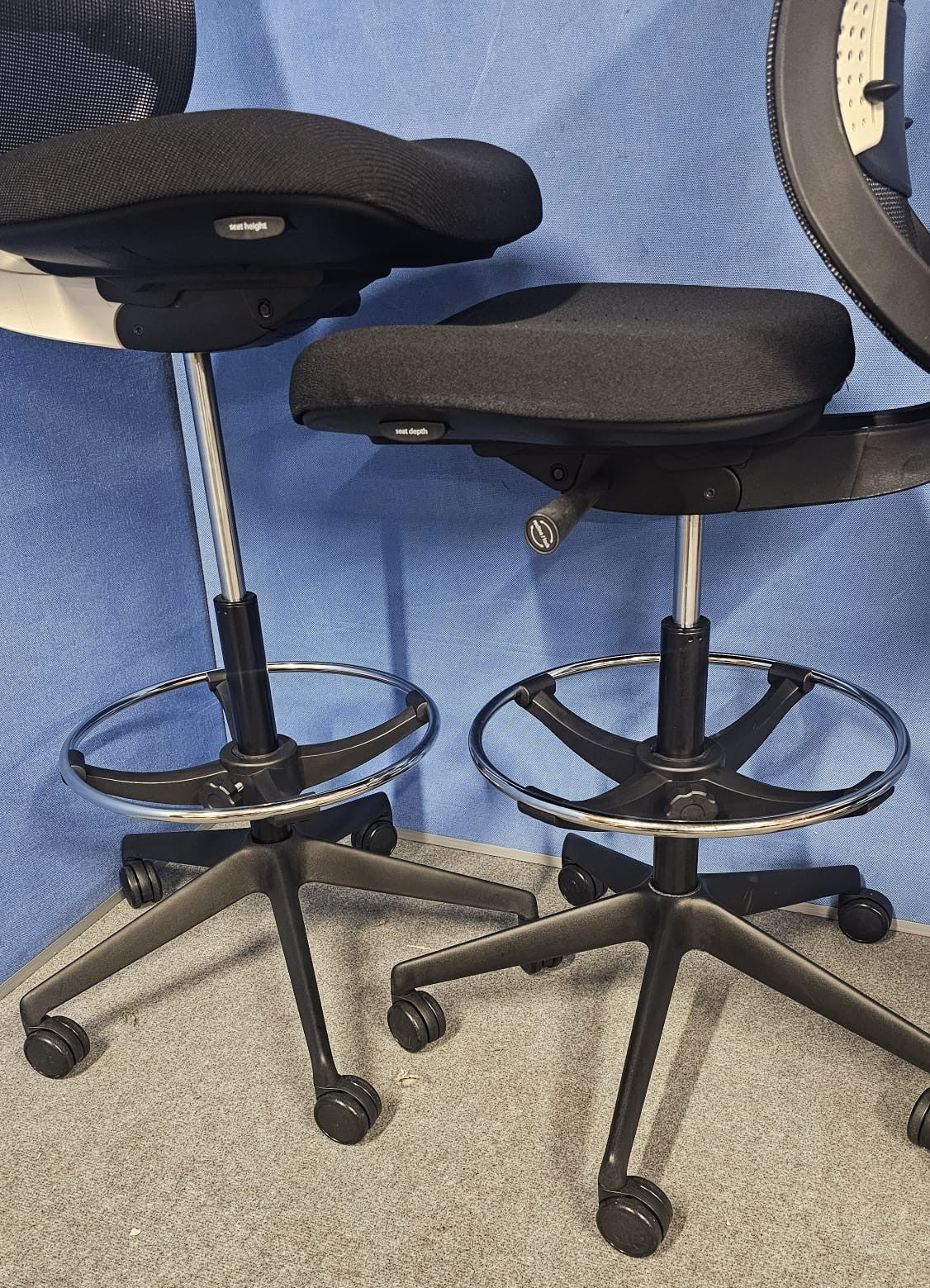 Draughtsman chair on blue wall and grey carpet