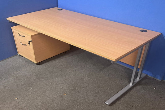 Wooden office desk with a blue wall in the background