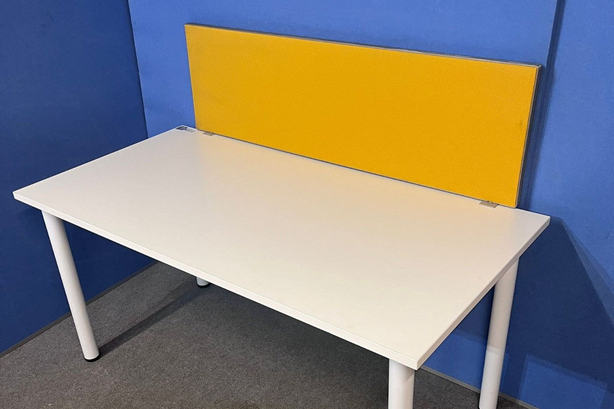 White desk with a yellow partition against a blue wall