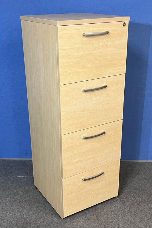 Maple four-drawer filing cabinet against a blue wall.