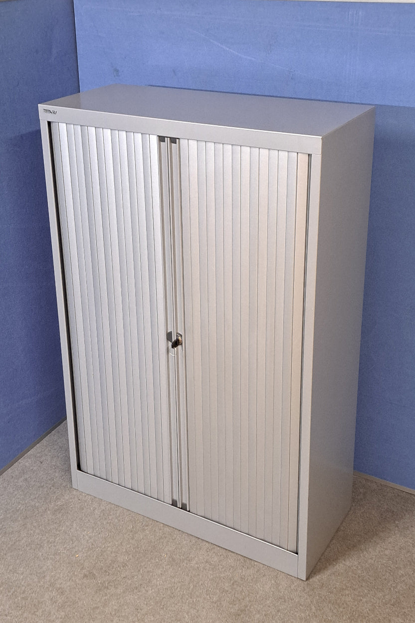 Metallic roller shutter door on a wall with a blue and grey background