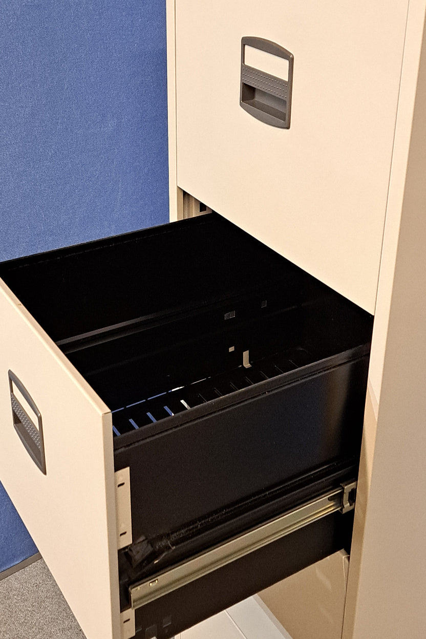Grey filing cabinet on blue wall and grey carpet