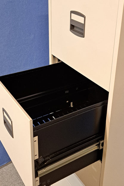 Grey filing cabinet on blue wall and grey carpet