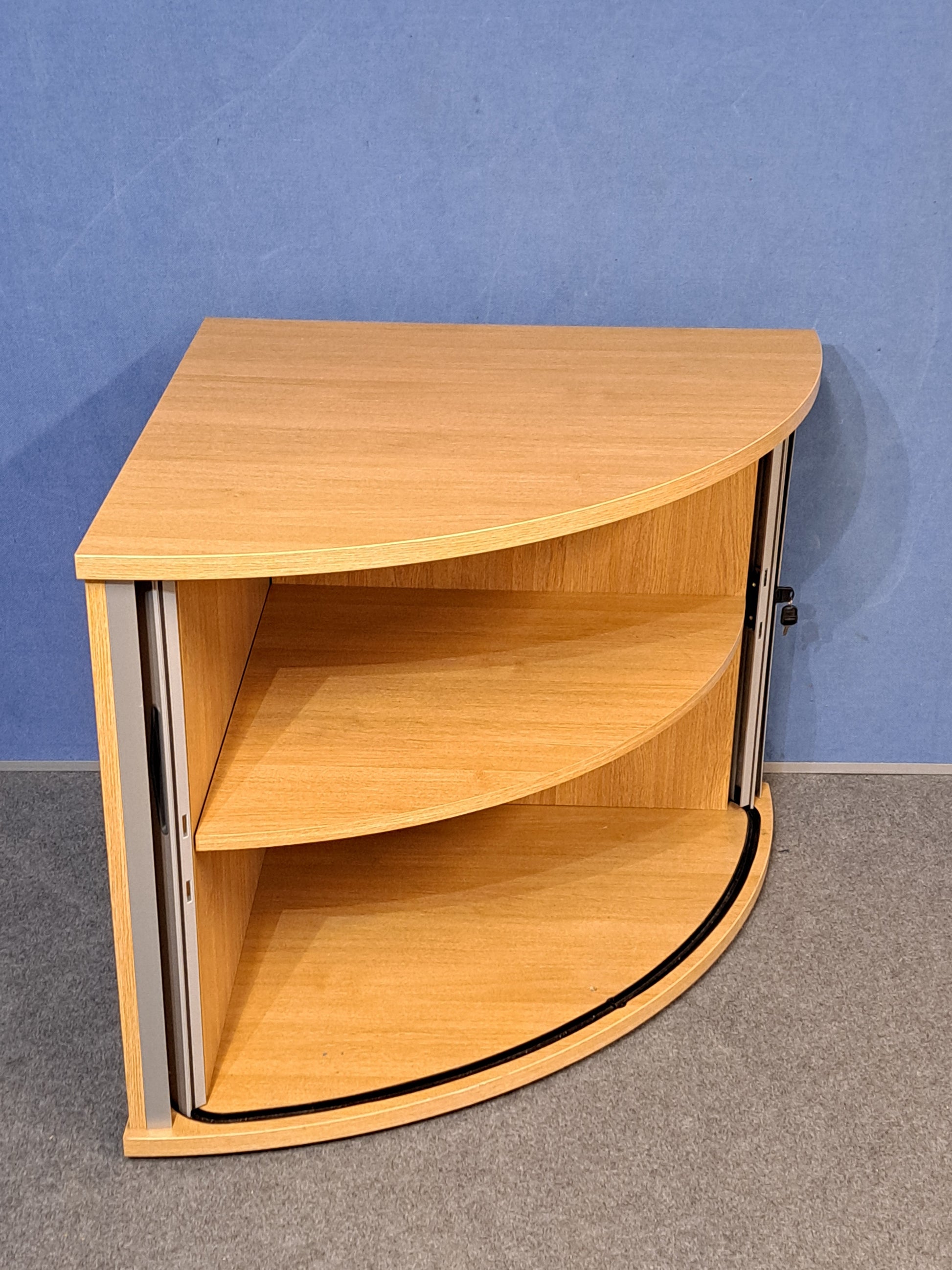 Tambour cupboard on a blue wall and grey carpet