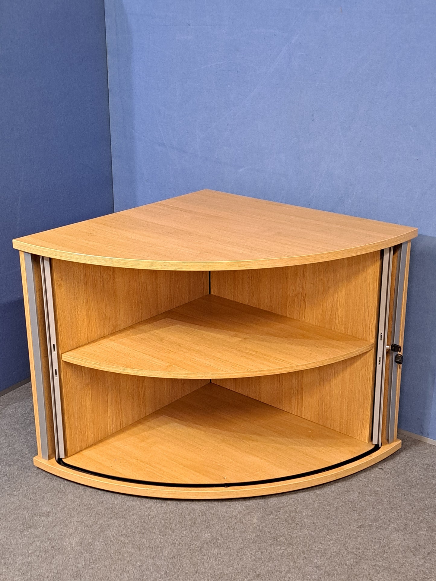 Tambour cupboard on a blue wall and grey carpet