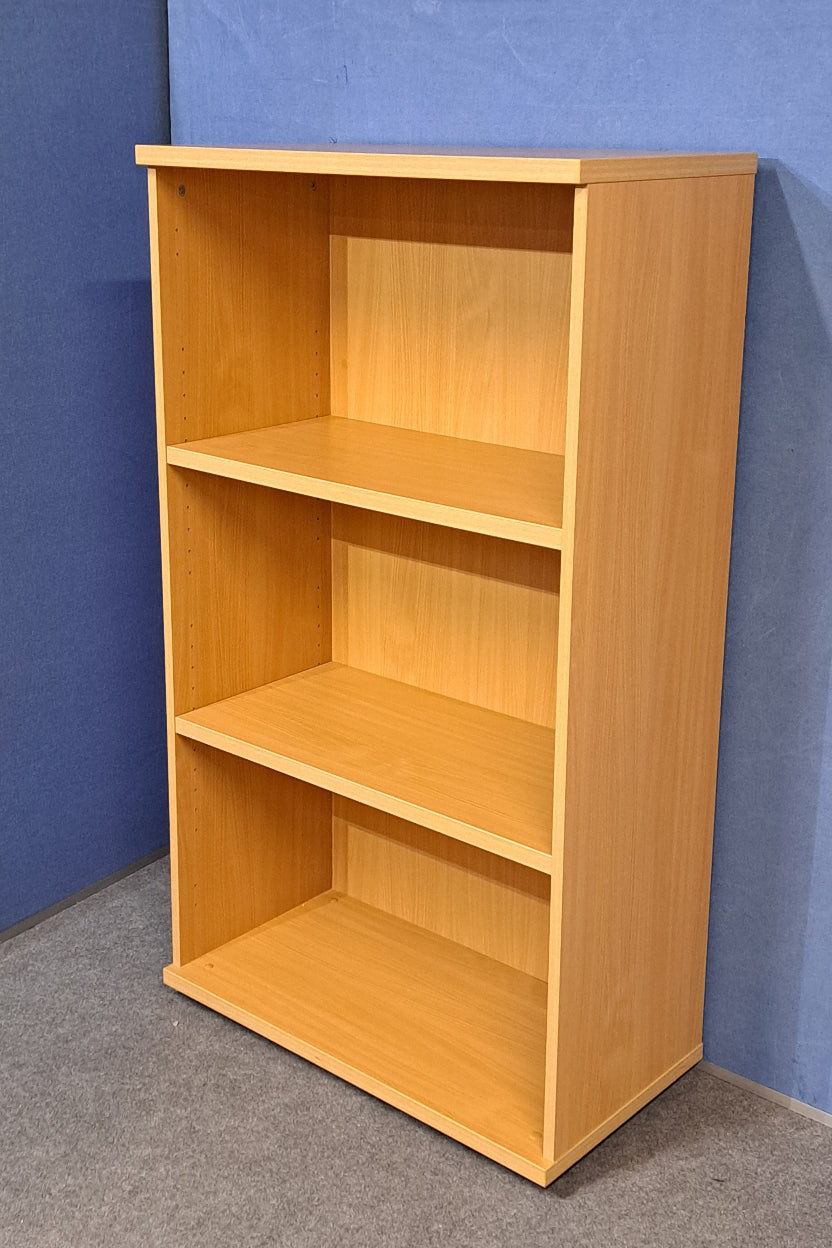 Wooden bookcase on a blue wall and grey carpet