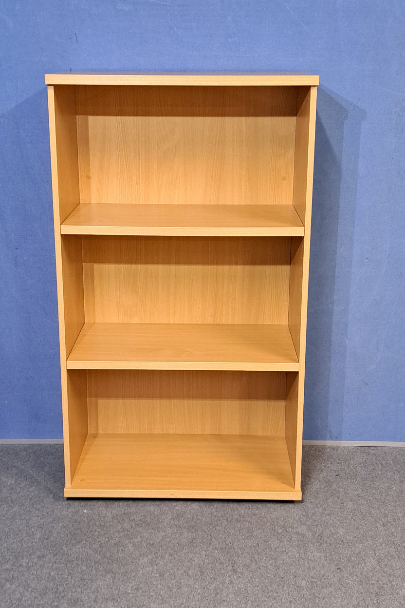 Wooden bookcase on a blue wall and grey carpet